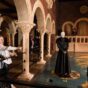 Couple looking at kings landing map with costumes